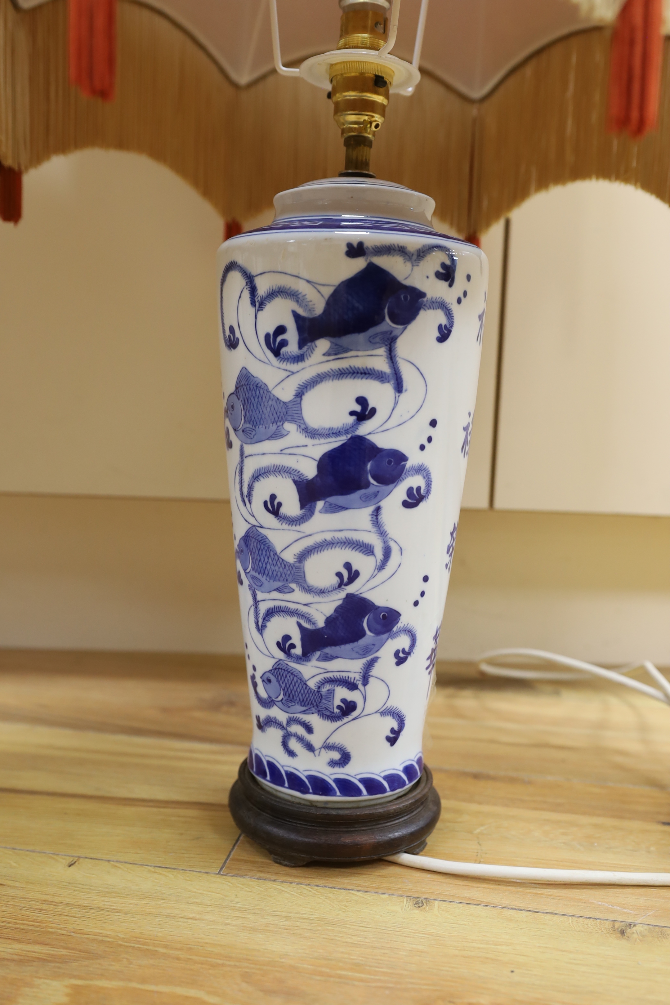 A pair of ‘Chinese’ blue and white table lamps with silk Pagoda shades, 69cm high overall
